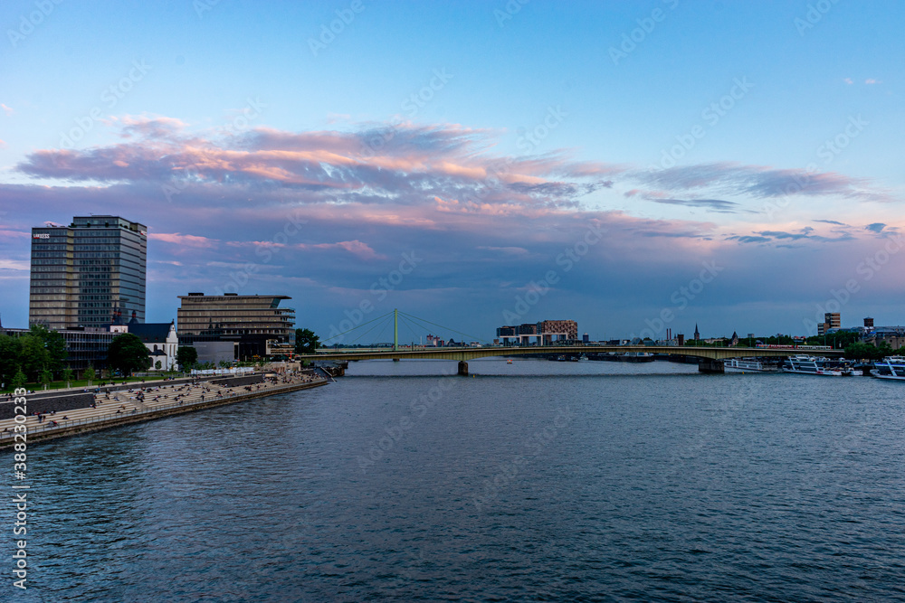 Fototapeta premium Germany, Cologne, a large body of water with a city in the background