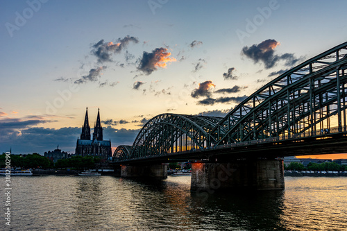 Germany, Cologne, a train crossing a bridge over a body of water