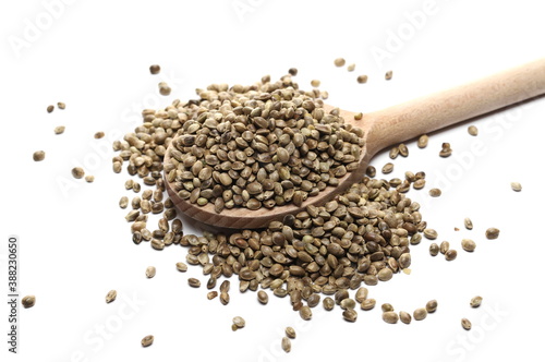 Hemp seeds pile with wooden spoon isolated on white background