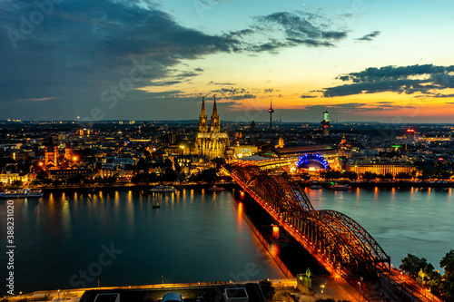 Germany, Cologne, a bridge over a body of water with a city in the background