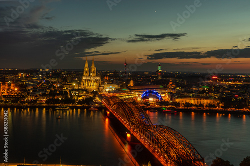 Germany, Cologne, a large body of water with a city in the night sky