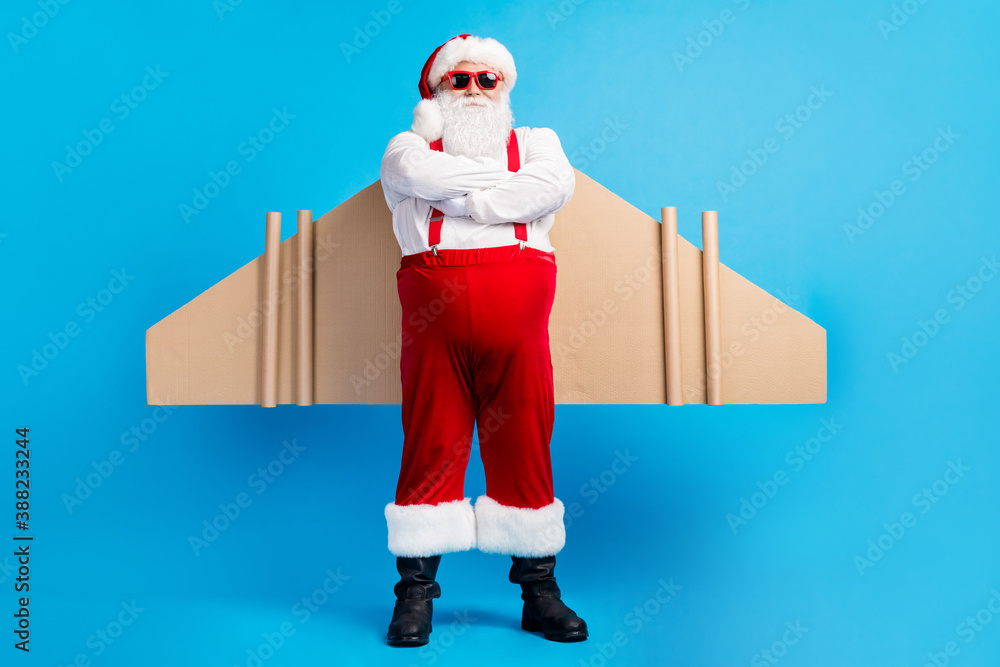 Full body photo of confident aviator white grey hair bearded santa claus  cross hands have craft wings x-mas christmas gift dream delivery wear  suspenders overall isolated blue color background Stock Photo |