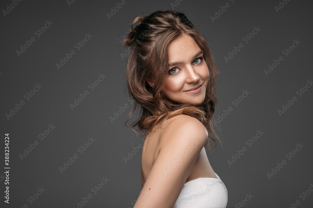 Fototapeta premium Portrait of a young woman isolated on gray background