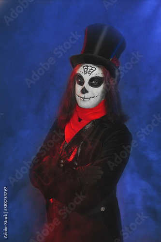 Handsome man with scary Halloween make up dead day calavera style with skull