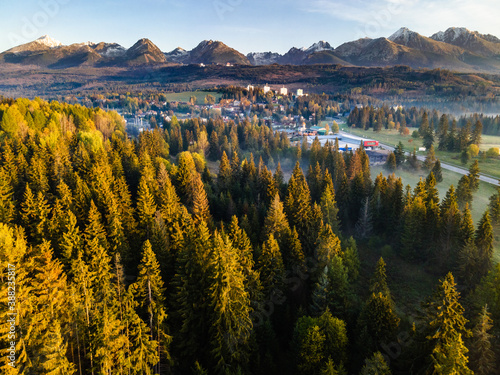 Panoramic View at High Tatra Mountains Ridge. Mist Over Trees at Autumn Sunrise. Aerial Drone View