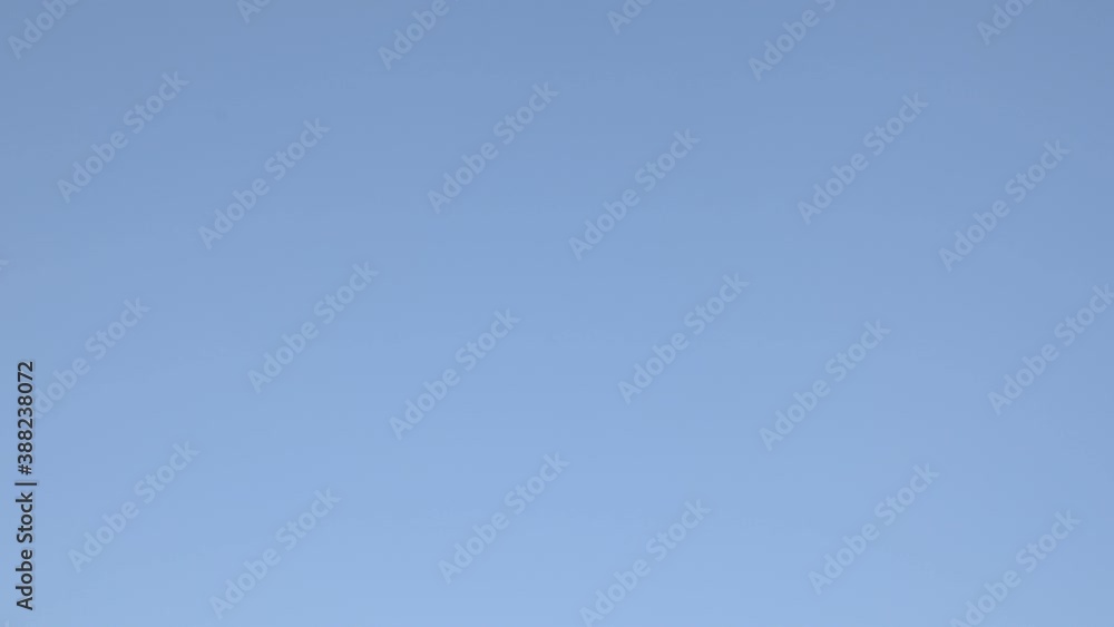 Football soccer ball flies over clear blue sky Football soccer ball flies over clear blue sky