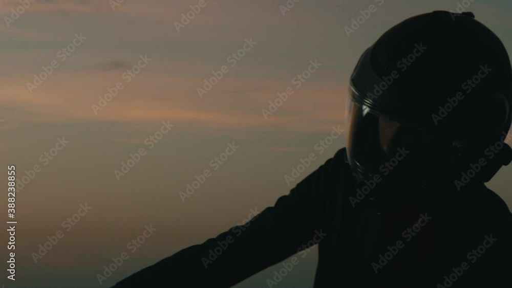 a man get on a motorcycle at sunrise a man get on a motorcycle at sunrise