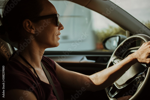 Woman driving her car with sunglasses. © daviles