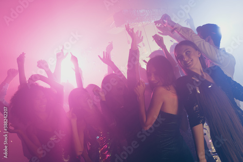 Photo of big group many pretty girls dance carefree glossy dress neon shiny spotlight modern club indoors