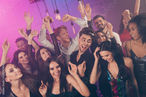 Photo of group many crazy carefree people neon illumination wear stylish trendy outfit modern club indoors