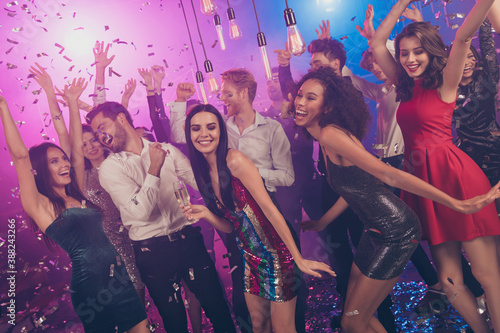 Photo of careless people celebrate pretty girls dance floor falling confetti wear stylish outfit modern club indoors