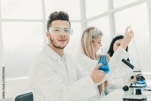 man scientist holding a flask of liquid for the experiment