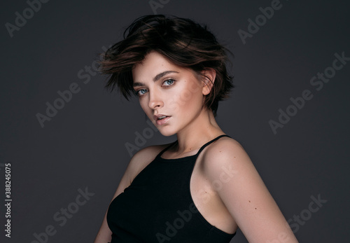 Fotobehang Portrait of a young beautiful brunette girl with short stylish hair
