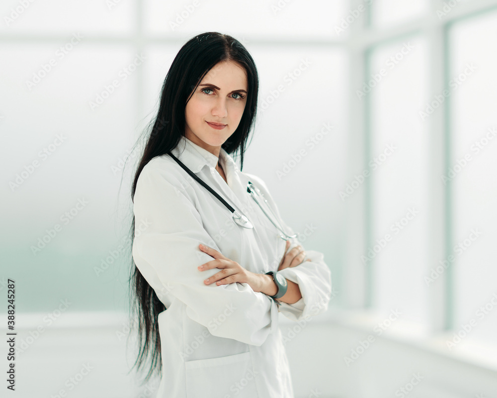 female therapist standing by the hospital window female therapist standing by the hospital window