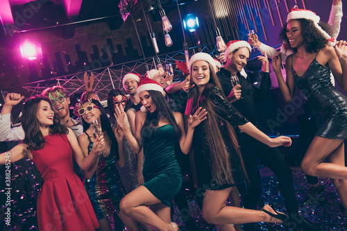 Photo of funky people careless festive mood celebrate party wear mini dress x-mas cap glasses modern club indoors