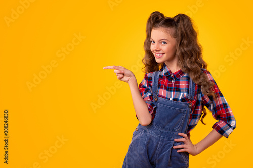 Positive girl pointing at empty space