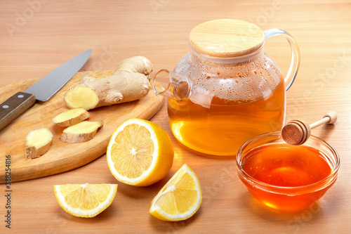  Ginger tea preparation with healthy ingredients on wooden background.