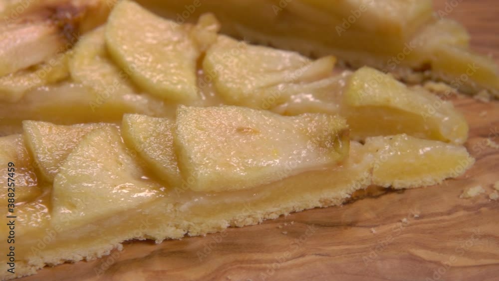 Panorama of a piece of delicious homemade french apple pie on the wooden board