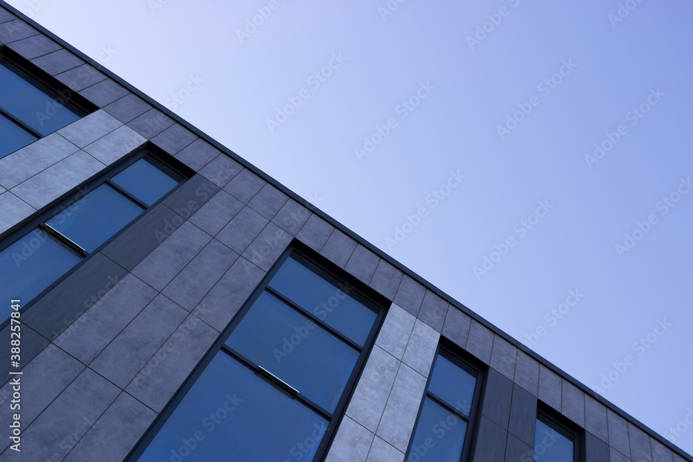 Part of the building with Windows, blue sky, diagonal.
