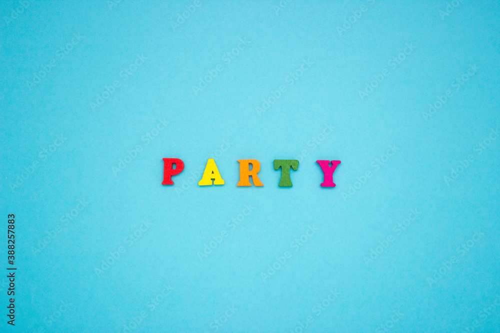 The word PARTY on a blue background of wooden multicolored letters. The word PARTY on a blue background of wooden multicolored letters.