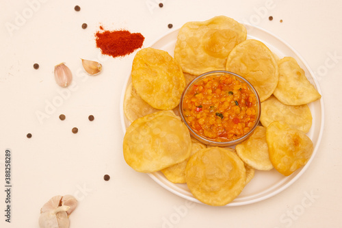 Indian cuisine. Luchi tortillas with cooked vegetables.