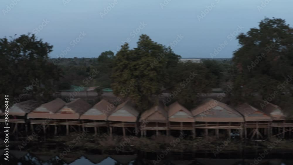 Flying pan over fishermen house and flocks of white birds flying over basin in Cambodia Flying pan over fishermen house and flocks of white birds flying over basin in Cambodia