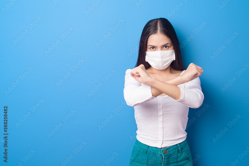 portrait of young woman is wearing face mask on Blue background portrait of young woman is wearing face mask on Blue background
