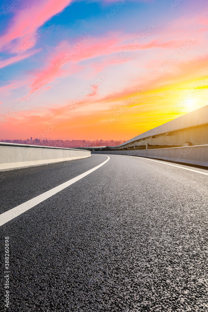 Asphalt viaduct road and city skyline in Hangzhou at sunset.