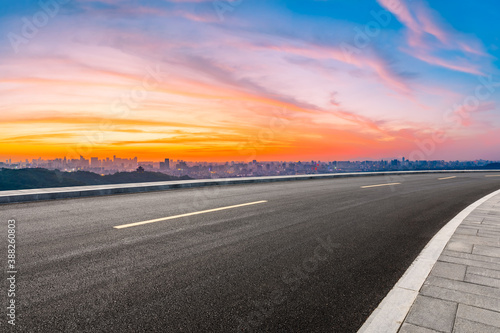 Asphalt viaduct road and city skyline in Hangzhou at sunset.