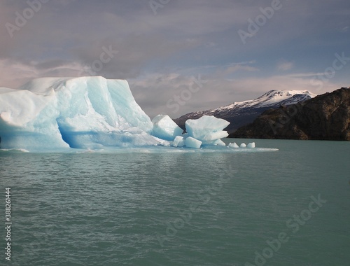 Landscape iceberg in polar regions in dramatic weather condition dark clouds reflect in the water and make ice blue