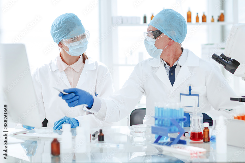 scientists discussing the results of research in a modern laboratory.