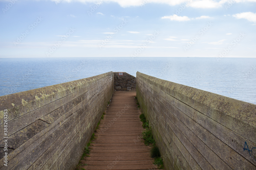 A footbridge over the Dawlish sea wall looking out across the English Channel in Devon, England