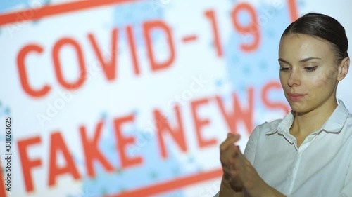 A beautiful girl disinfects her hands, gets the latest information about the epidemic when she finishes the pandemic and lockdown, covid 19 fake news
