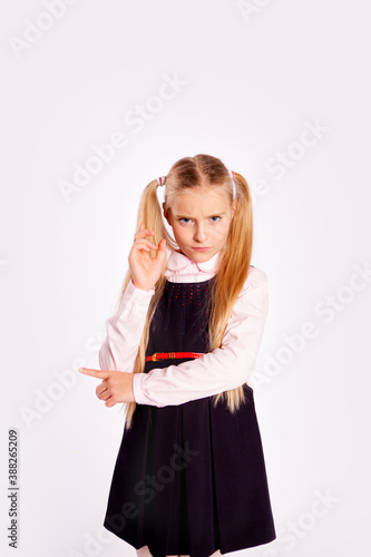 Картината върху платно distrustful schoolgirl planning something straightens her hair