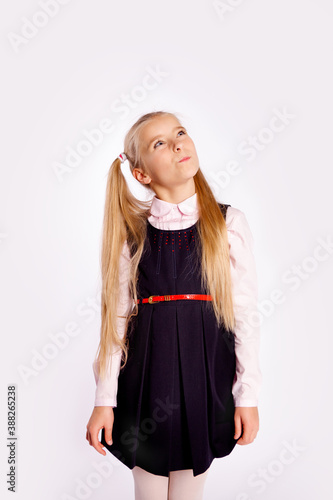 Картината върху платно distrustful schoolgirl planning something straightens her hair