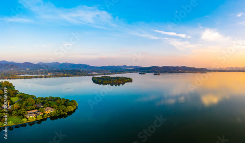 Beautiful West Lake and city skyline in Hangzhou at sunrise,China.aerial view. © ABCDstock