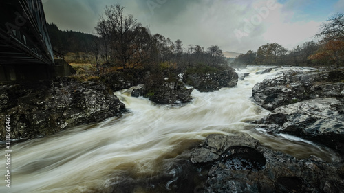 long exposure shot of the waterfalls in glen orchy near bridge of orchy in the argyll region of the highlands of scotland during autumn photo