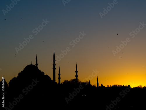 Black silhouette of the city with mosques at sunset. Istanbul cityscape at twilight.