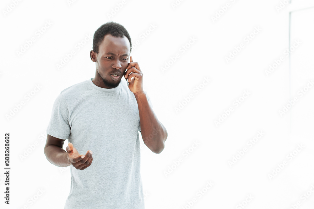 serious young man talking on his smartphone.
