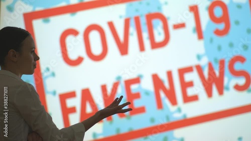 A beautiful girl looks at the screen, gets the latest information about the epidemic when she finishes the pandemic and lockdown, covid 19 fake news
