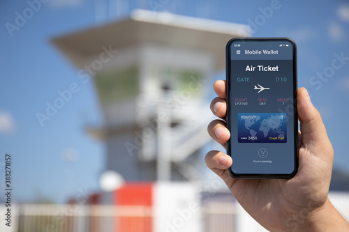 woman hand holding phone with airplane ticket application airlines on screen