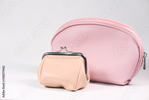 close up of pink color women purse on white background 