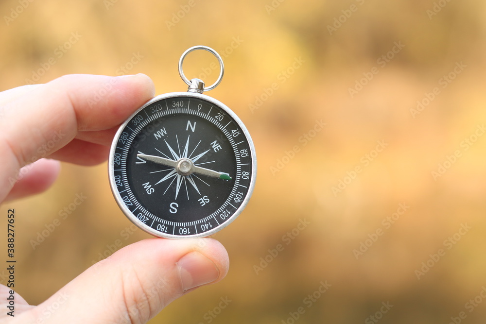 Old classic navigation compass on natural background as symbol of tourism with compass, travel with compass and outdoor activities with compass Old classic navigation compass on natural background as symbol of tourism with compass, travel with compass and outdoor activities with compass