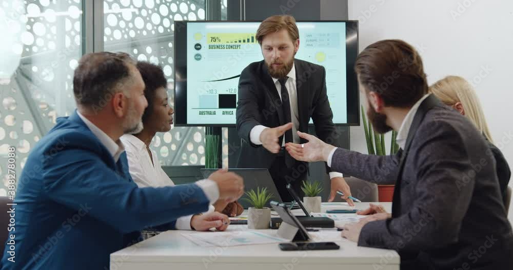 Handsome confident in good mood bearded boss shaking hand with anothers members of joint negotiations in conference room,slow motion Handsome confident in good mood bearded boss shaking hand with anothers members of joint negotiations in conference room,slow motion