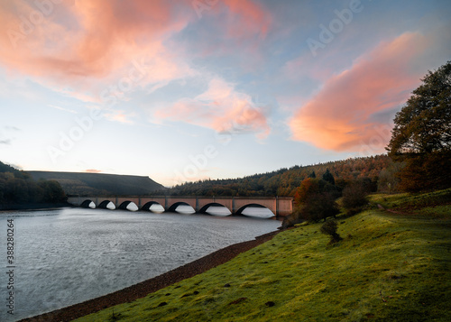 bridge over the river with pink clouds and blue sky