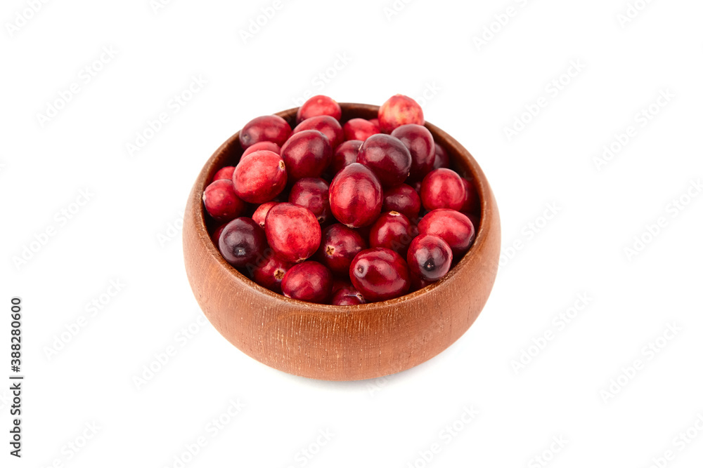 Cranberries in wooden bowl isolated on white Cranberries in wooden bowl isolated on white