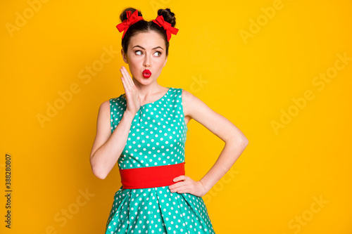 Portrait of nice pretty shy modest feminine girl looking aside pout lips copy space isolated over vibrant yellow color background