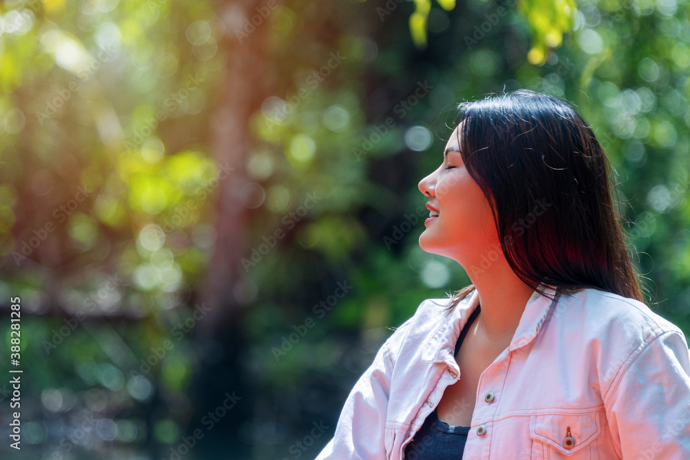 Close up side view young woman relax breathing fresh air while travel on nature background. Lovely girl close eyes doing deep breath exercises with positive emotion success. Close up side view young woman relax breathing fresh air while travel on nature background. Lovely girl close eyes doing deep breath exercises with positive emotion success.