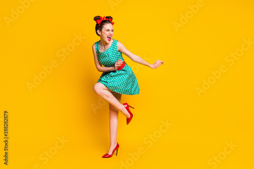 Full length body size view of lovely slim cheerful girl dancing disco having fun chill out isolated on bright yellow color background