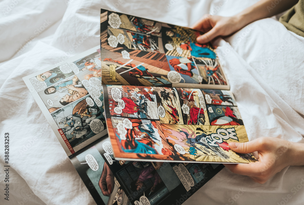 Obraz premium Woman reading comic book in the bed at home. Rostov-on-Don, Russia. 14 April 2020
